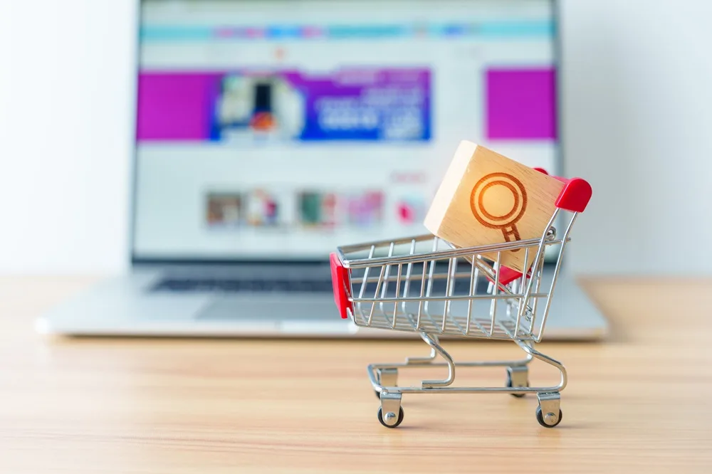 Business owner reviewing the benefits of ecommerce on a laptop